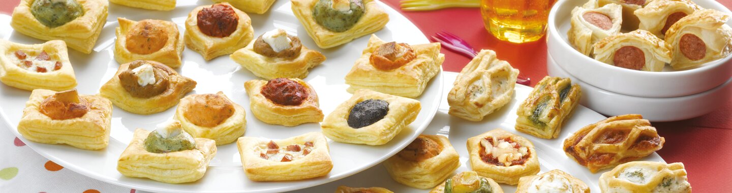 Different plates with mini puff pastries